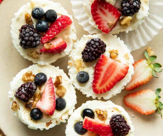 Frozen Yogurt Granola Cups topped with fruit, nuts, and honey.
