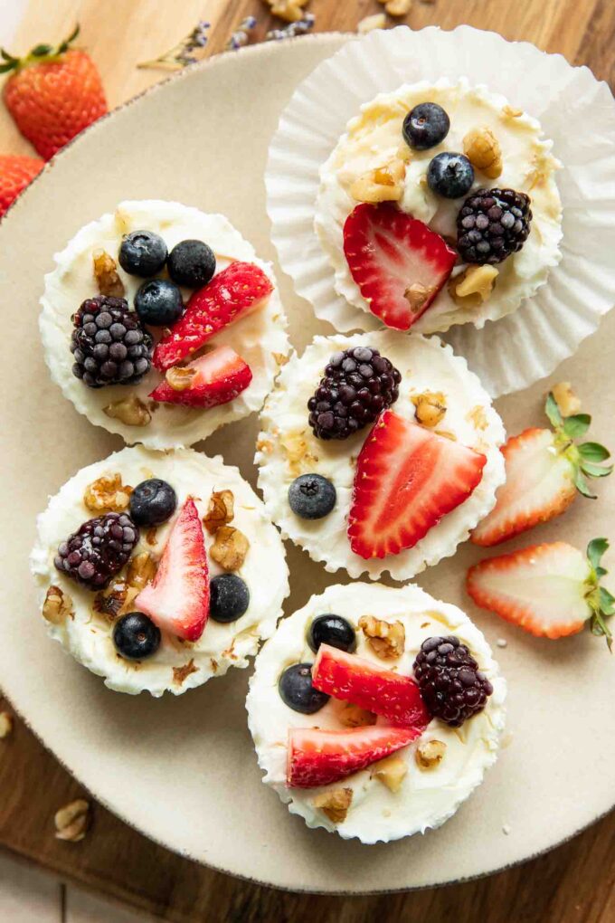Frozen Yogurt Granola Cups topped with fruit, nuts, and honey.
