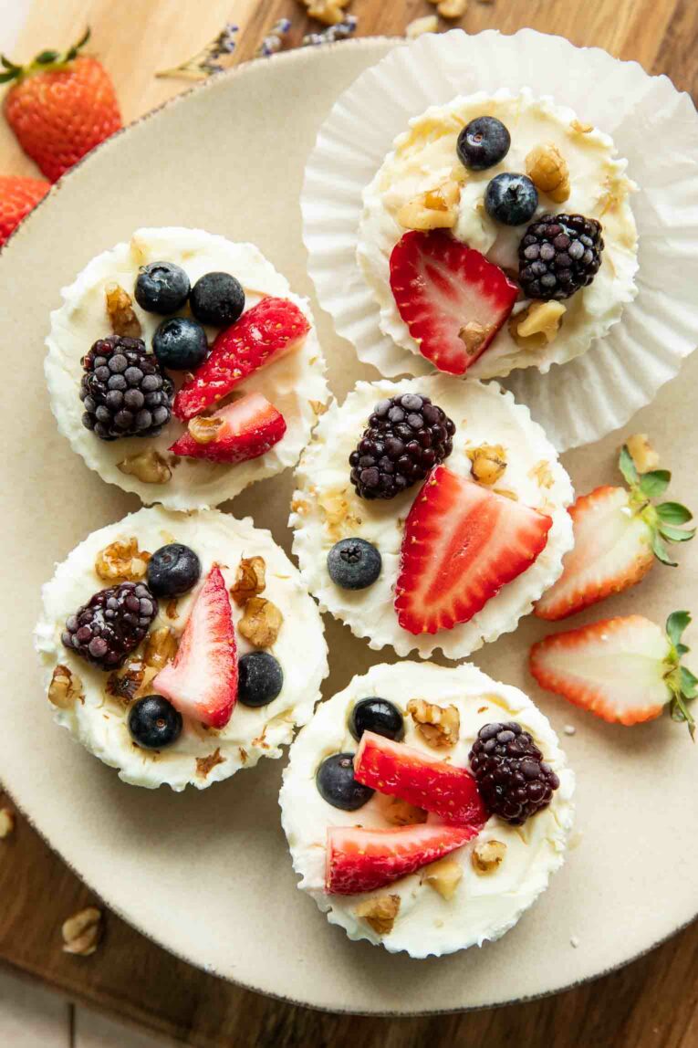 Frozen Yogurt Granola Cups topped with fruit, nuts, and honey.
