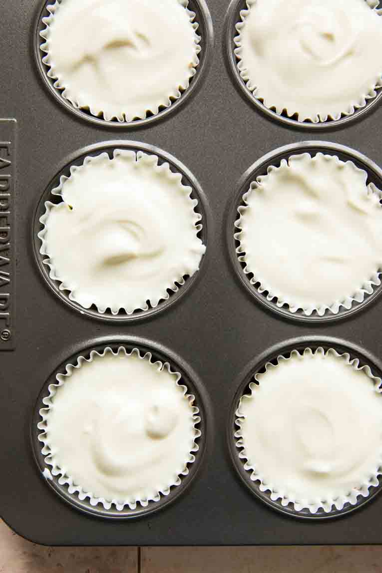 Yogurt cups in a muffin tin.