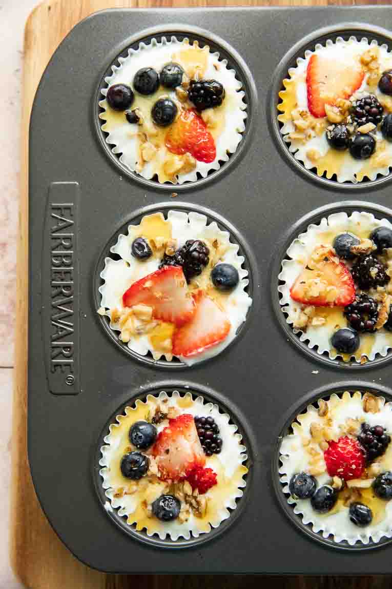 Fruit and nut yogurt granola cups in a muffin tin.