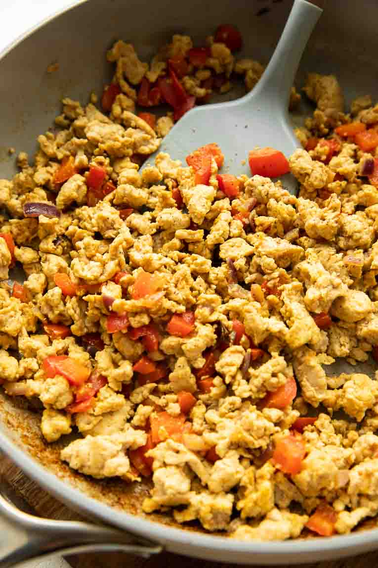 Ground turkey and bell peppers in a skillet.
