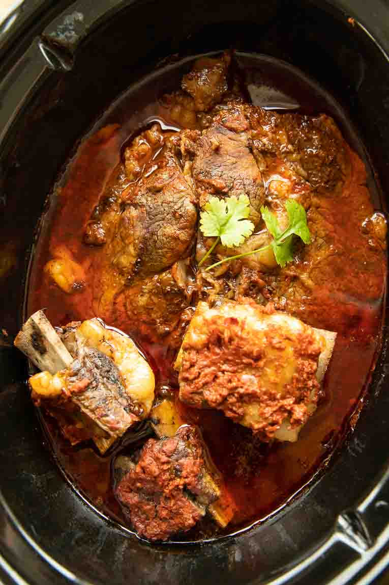 Cooked Birria meat in a crockpot.