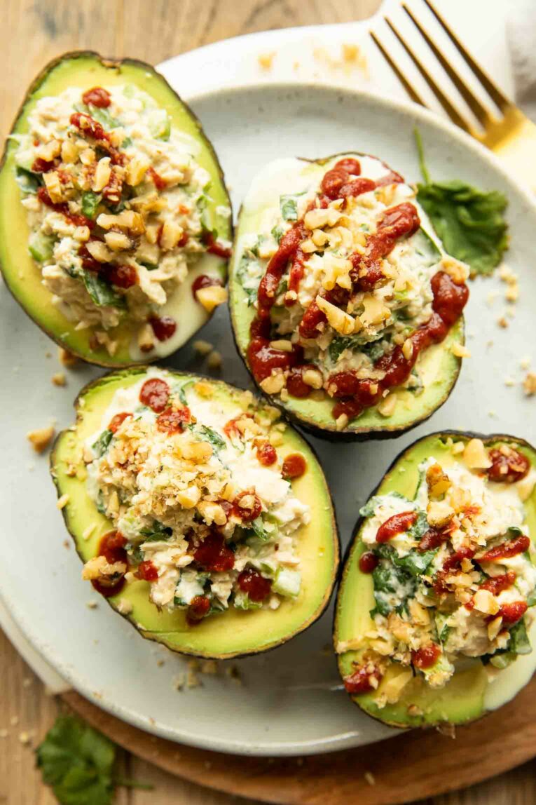 Close up of 4 Spicy Sriracha Tuna Stuffed Avocados on a plate.