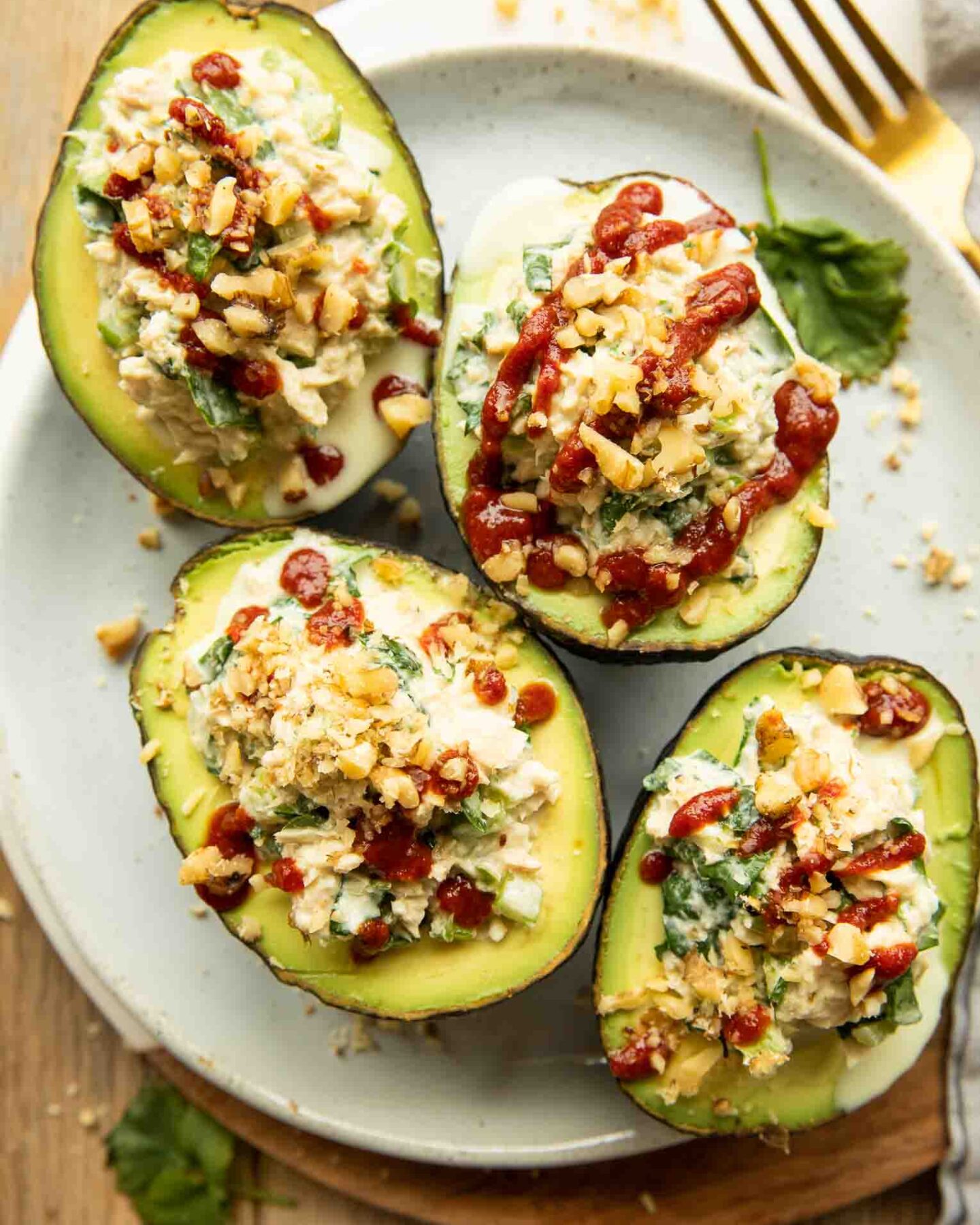 Top photo of Spicy Sriracha Tuna Stuffed Avocados on a plate.