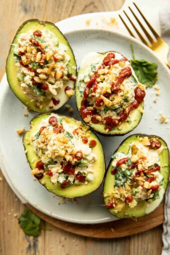 Top photo of Spicy Sriracha Tuna Stuffed Avocados on a plate.