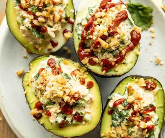 Top photo of Spicy Sriracha Tuna Stuffed Avocados on a plate.
