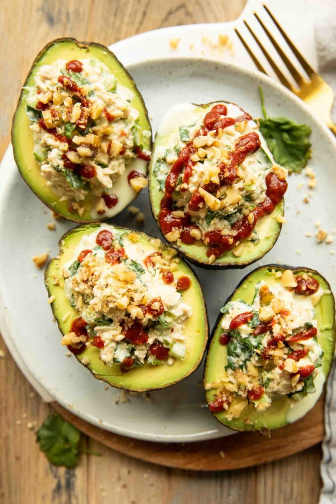 Top photo of Spicy Sriracha Tuna Stuffed Avocados on a plate.