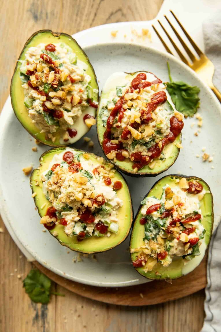 Avocados stuffed with tuna salad and sriracha drizzle.