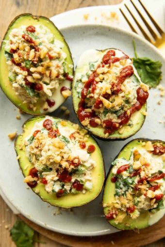 Top photo of Spicy Sriracha Tuna Stuffed Avocados on a plate.