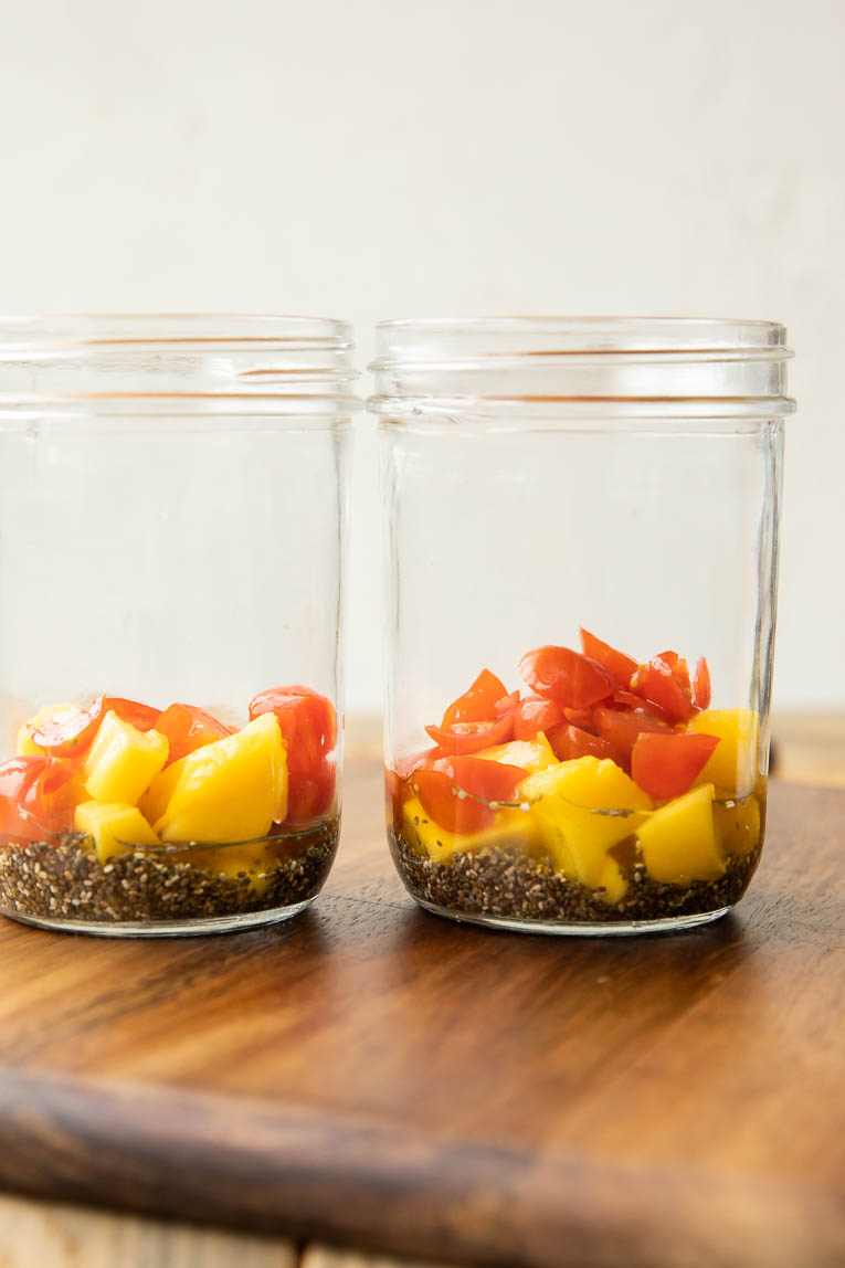 chia seeds, mangos and tomatoes in a jar.