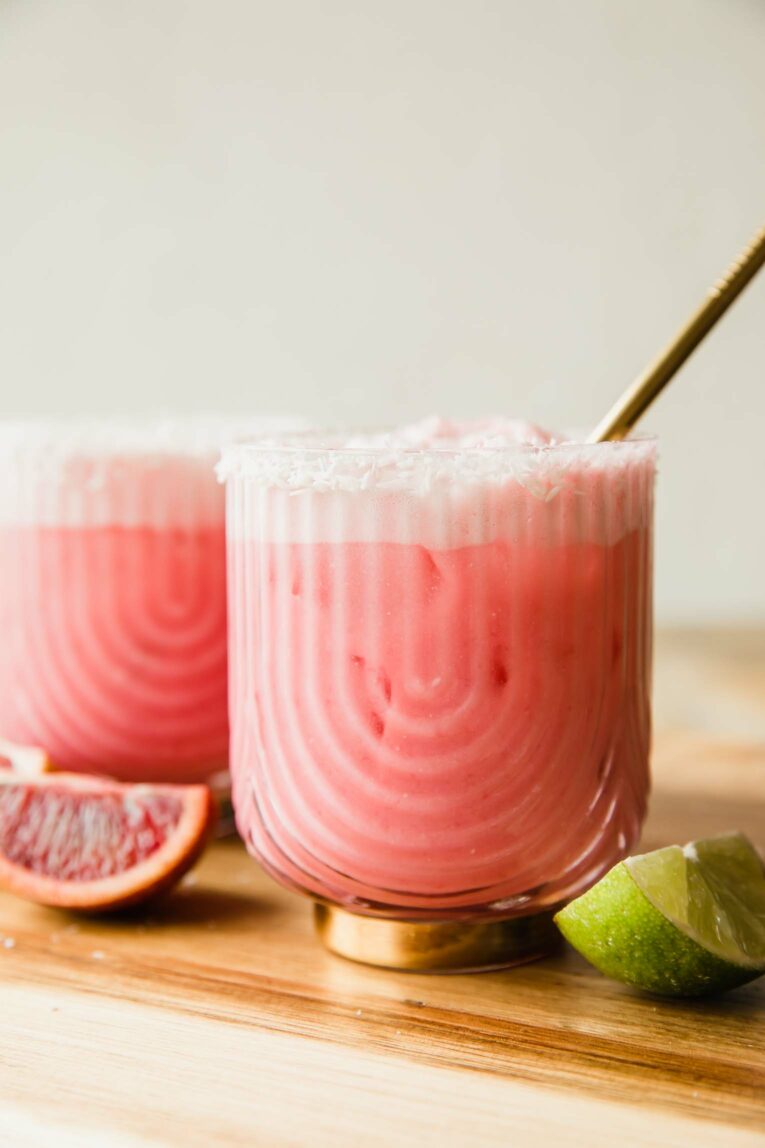 Creamy Blood Orange Mocktail in a glass with a straw.