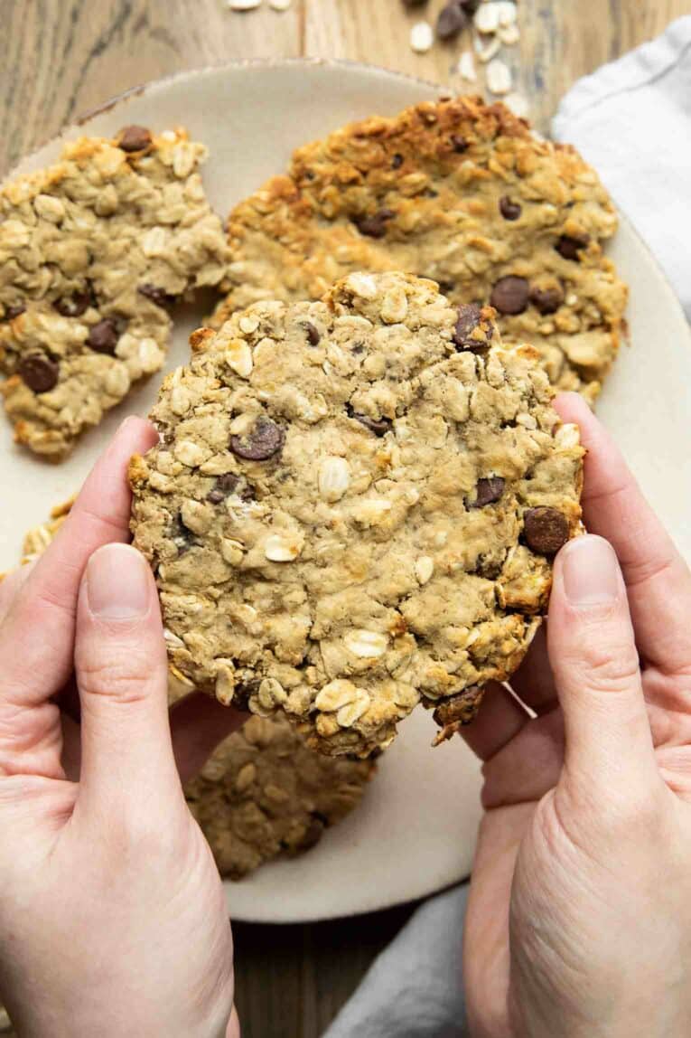 Hand holding giant air fryer cookie.