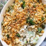 Poppy seed chicken casserole recipe with a spoon in casserole dish.