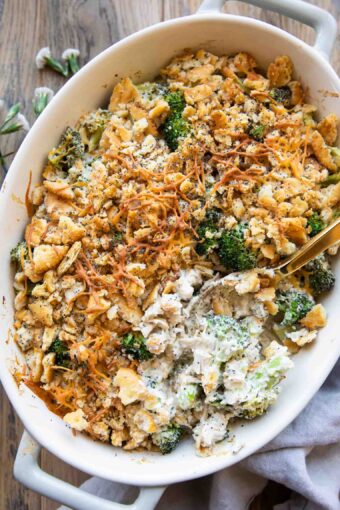 Poppy seed chicken casserole recipe with a spoon in casserole dish.