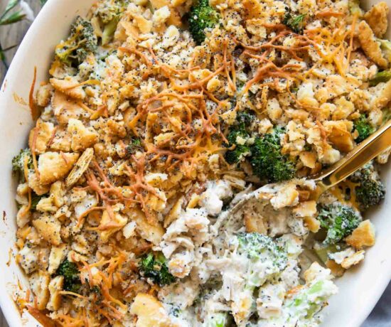 Poppy seed chicken casserole recipe with a spoon in casserole dish.