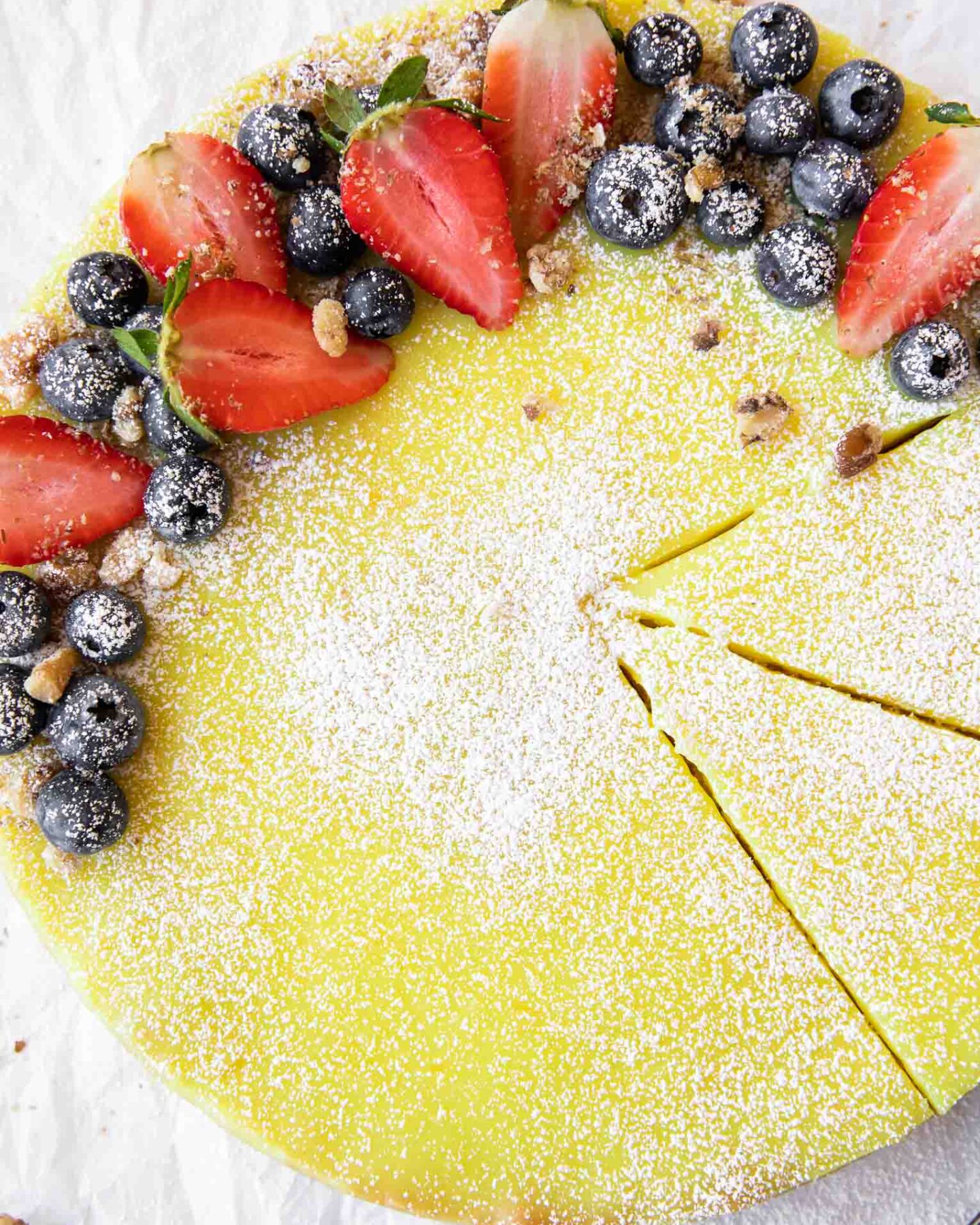 Vegan Berry Lemon Curd Tart recipe on parchment paper.