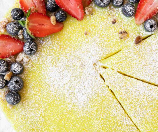 Vegan Berry Lemon Curd Tart recipe on parchment paper.