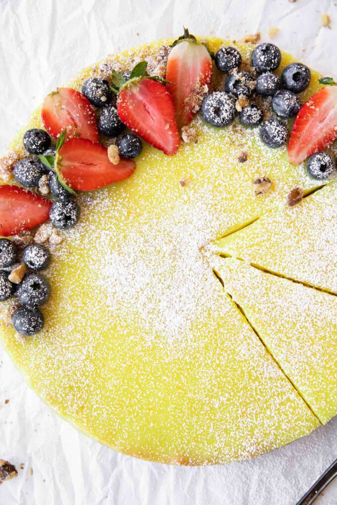 Vegan Berry Lemon Curd Tart recipe on parchment paper.