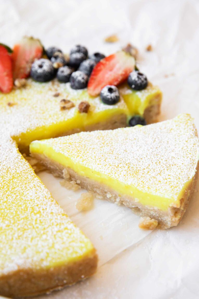 Angled photo of Vegan Berry Lemon Curd Tart slice.