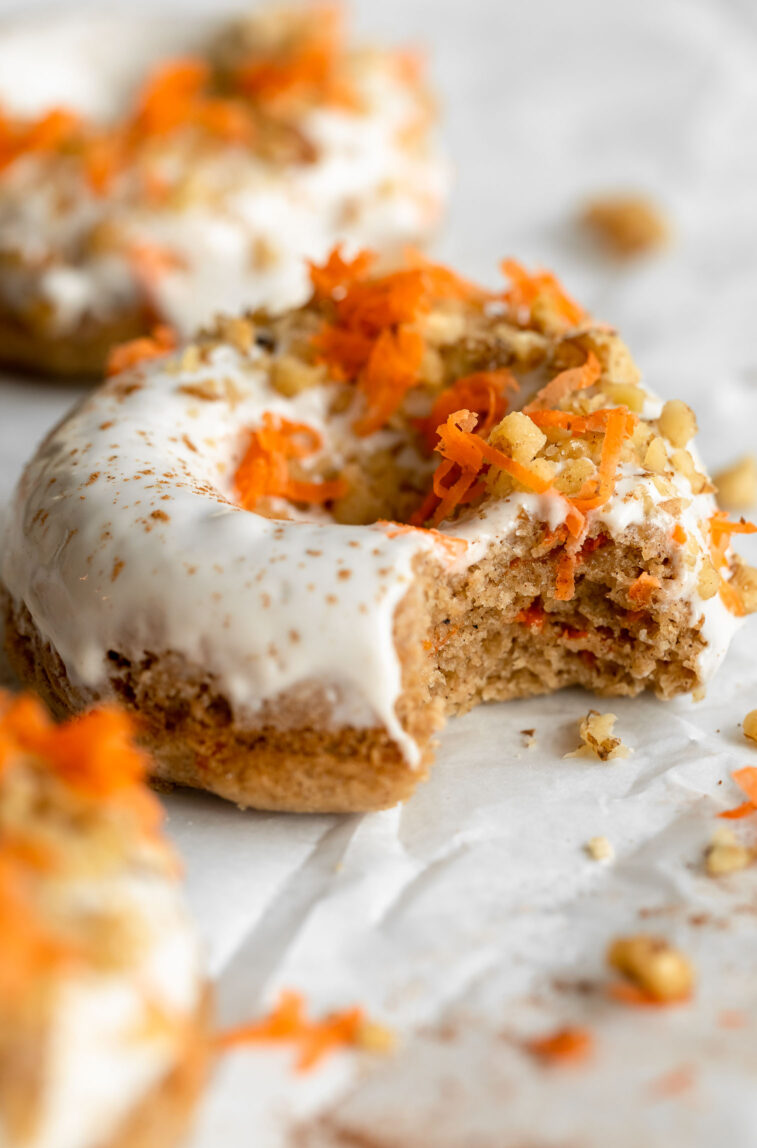 Angled close up of Vegan Carrot Cake Donut with bite taken out.