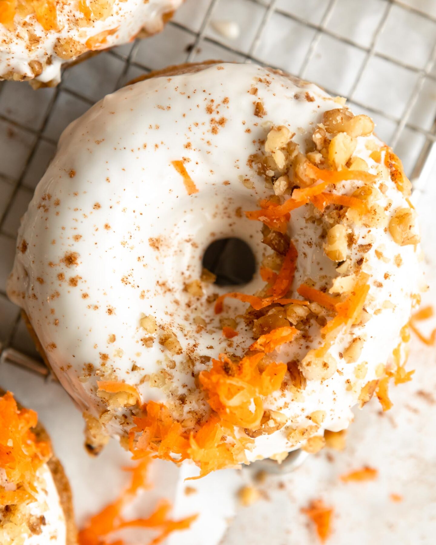 Top shot photo of Vegan Carrot Cake Donuts on a cooling rack.