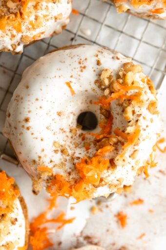 Top shot photo of Vegan Carrot Cake Donuts on a cooling rack.