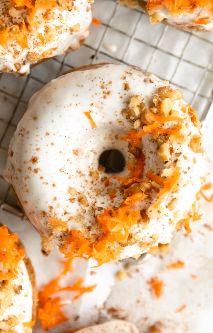 Top shot photo of Vegan Carrot Cake Donuts on a cooling rack.