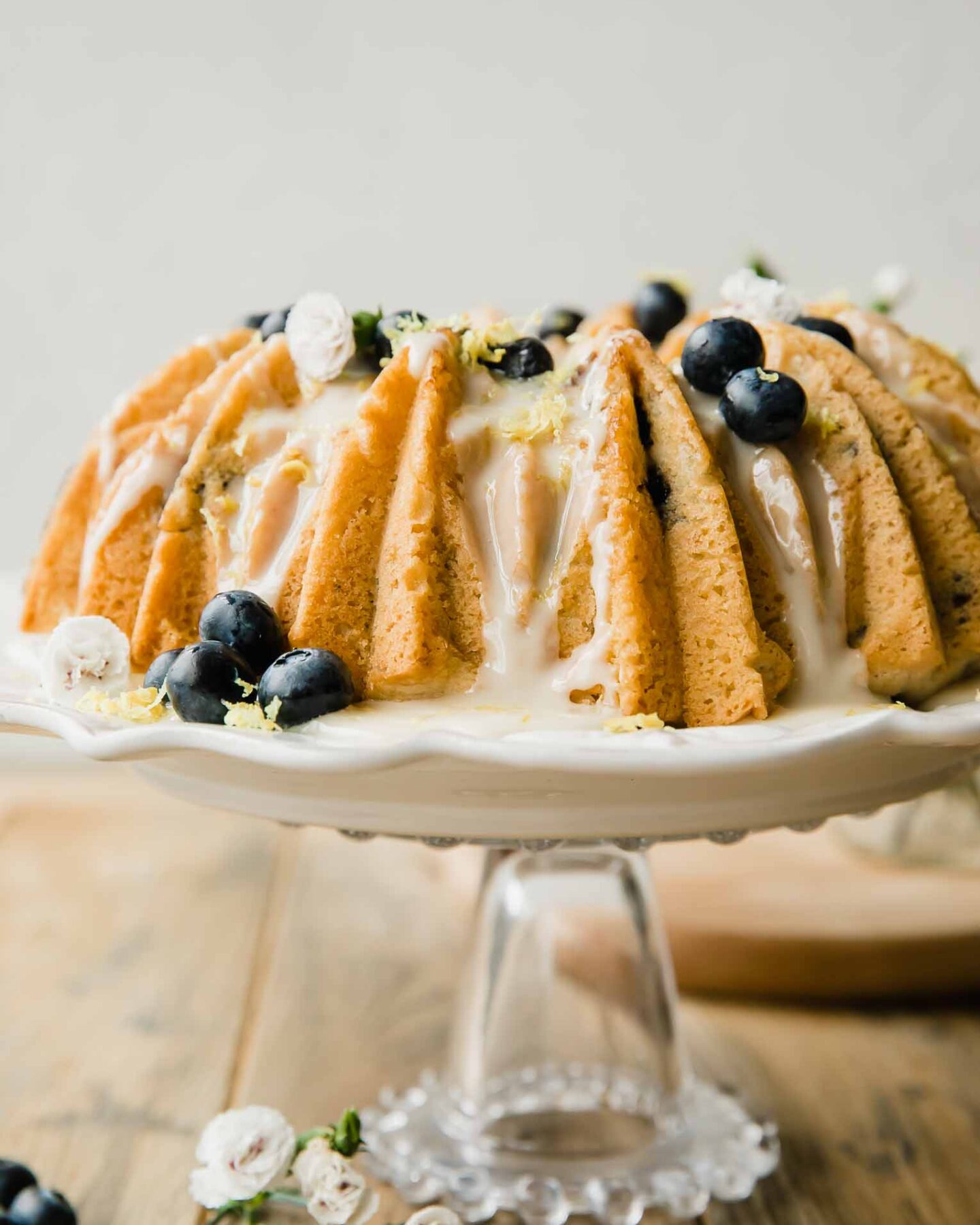 Vegan Lemon Blueberry Cake recipe on a cake stand.