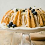 Vegan Lemon Blueberry Cake recipe on a cake stand.