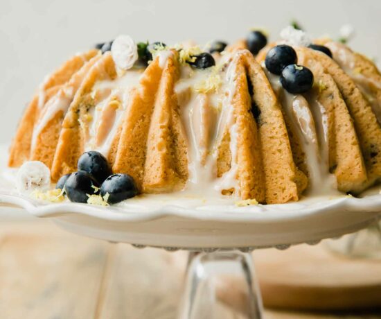 Vegan Lemon Blueberry Cake recipe on a cake stand.