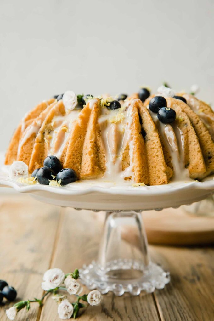 Vegan Lemon Blueberry Cake recipe on a cake stand.