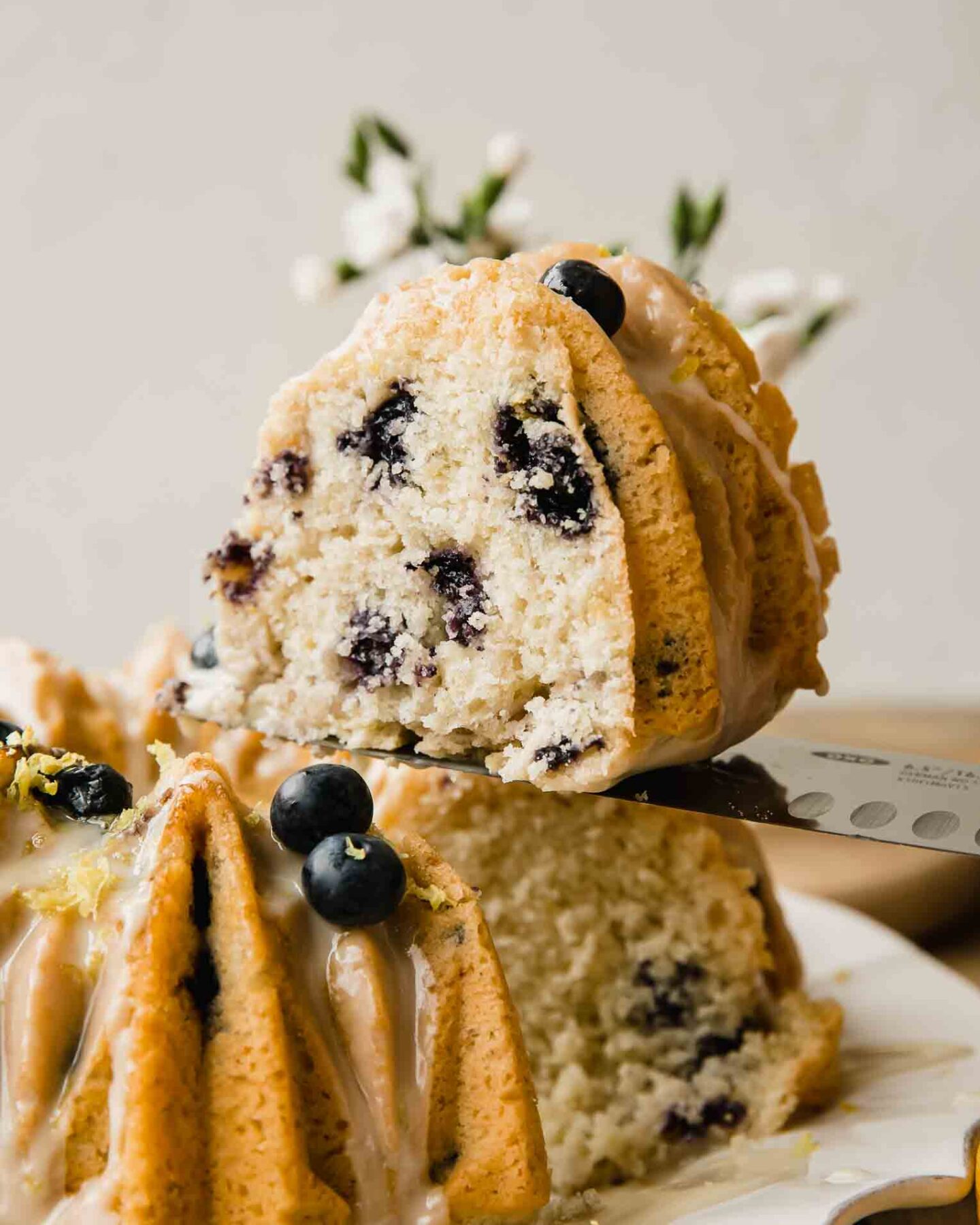 Slice of vegan lemon cake with blueberries.