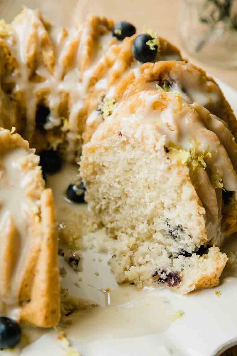 Vegan Lemon Blueberry Cake with slice taken out.