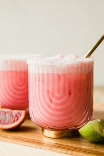 Creamy Blood Orange Mocktail in a glass with a straw.