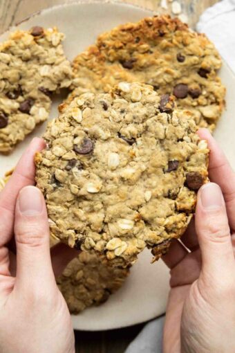 Hand holding giant air fryer cookie.
