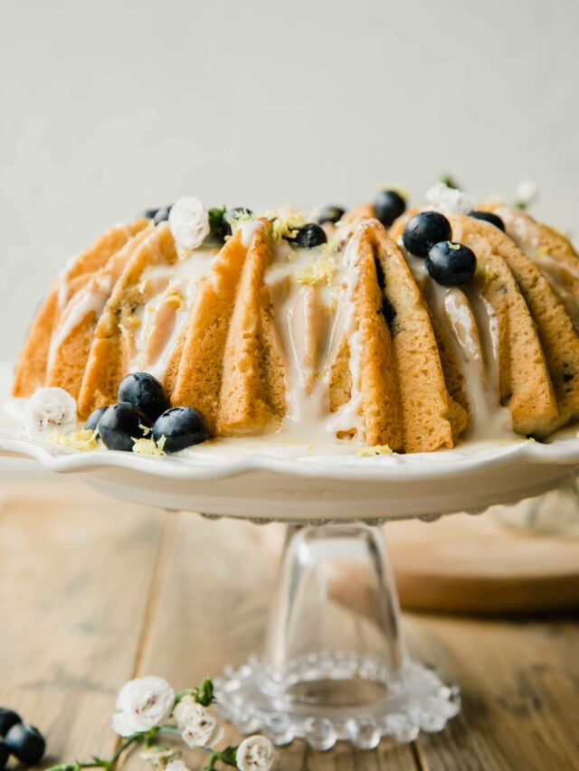 Vegan Lemon Blueberry Cake recipe on a cake stand.
