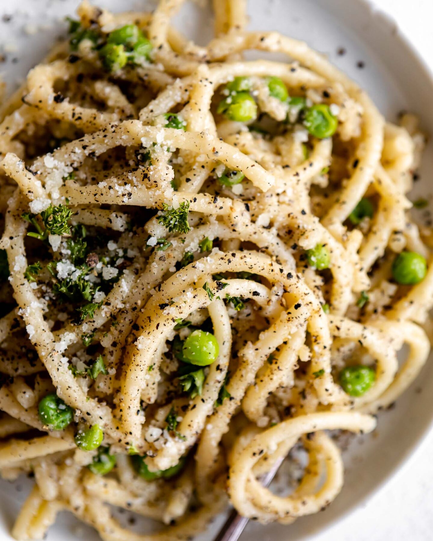 Top shot photo of Bucatini Cacio E Pepe on a plate.