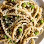 Top shot photo of Bucatini Cacio E Pepe on a plate.