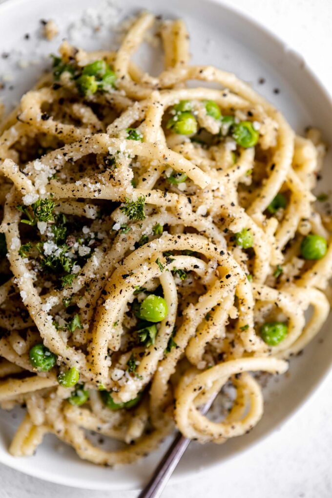 Top shot photo of Bucatini Cacio E Pepe on a plate.