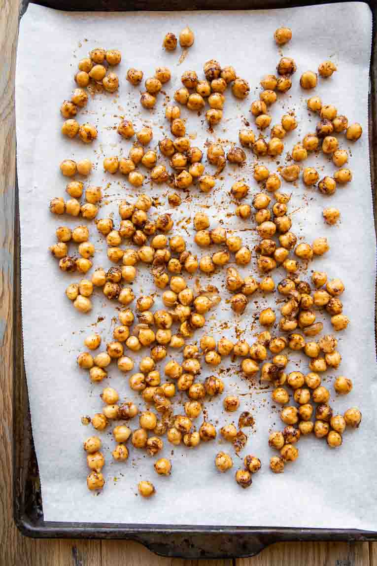 Roasted chili cumin chickpeas on a baking sheet.