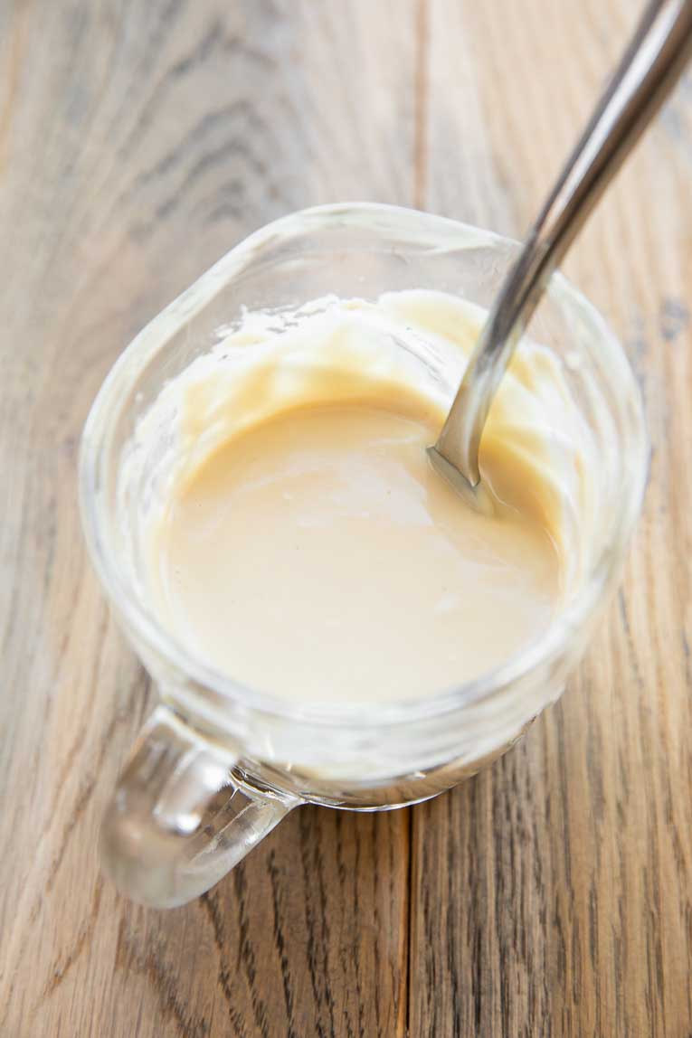 Tahini lime dressing in a bowl.