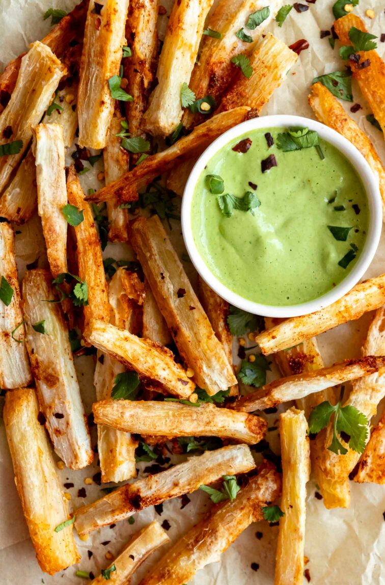 Close up of Yuca Fries with a green cilantro sauce.