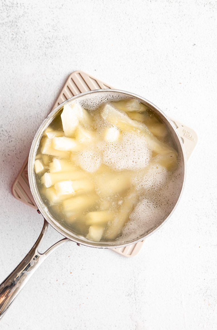 Yuca root being boiled in water.