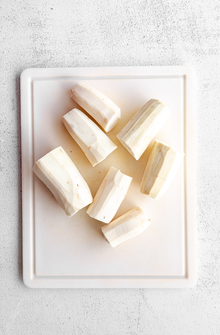 Yuca root peeled on a cutting board.