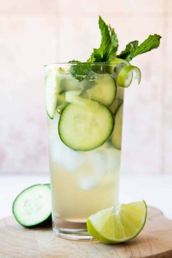 Cucumber Lime Spritzer (Non-Alcoholic) garnished with cucumbers, lime twist, and mint.