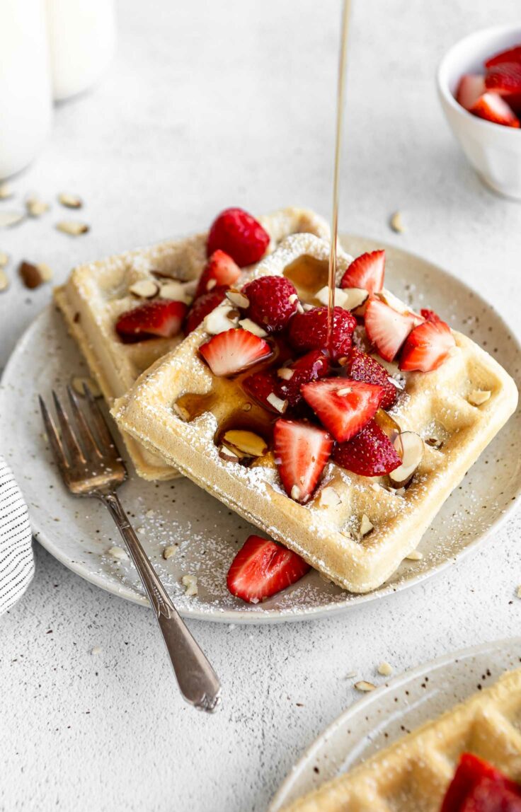 Syrup pouring over Gluten-Free Waffles.
