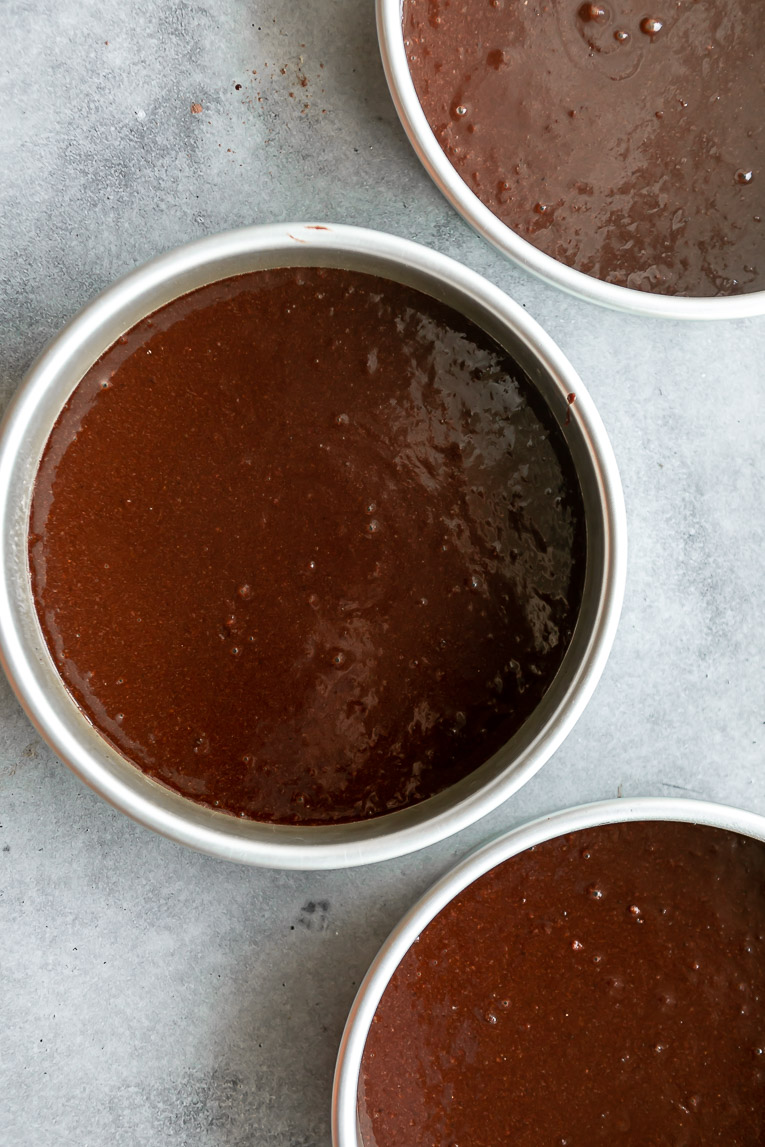 Healthy chocolate cake batter in 3 pans.