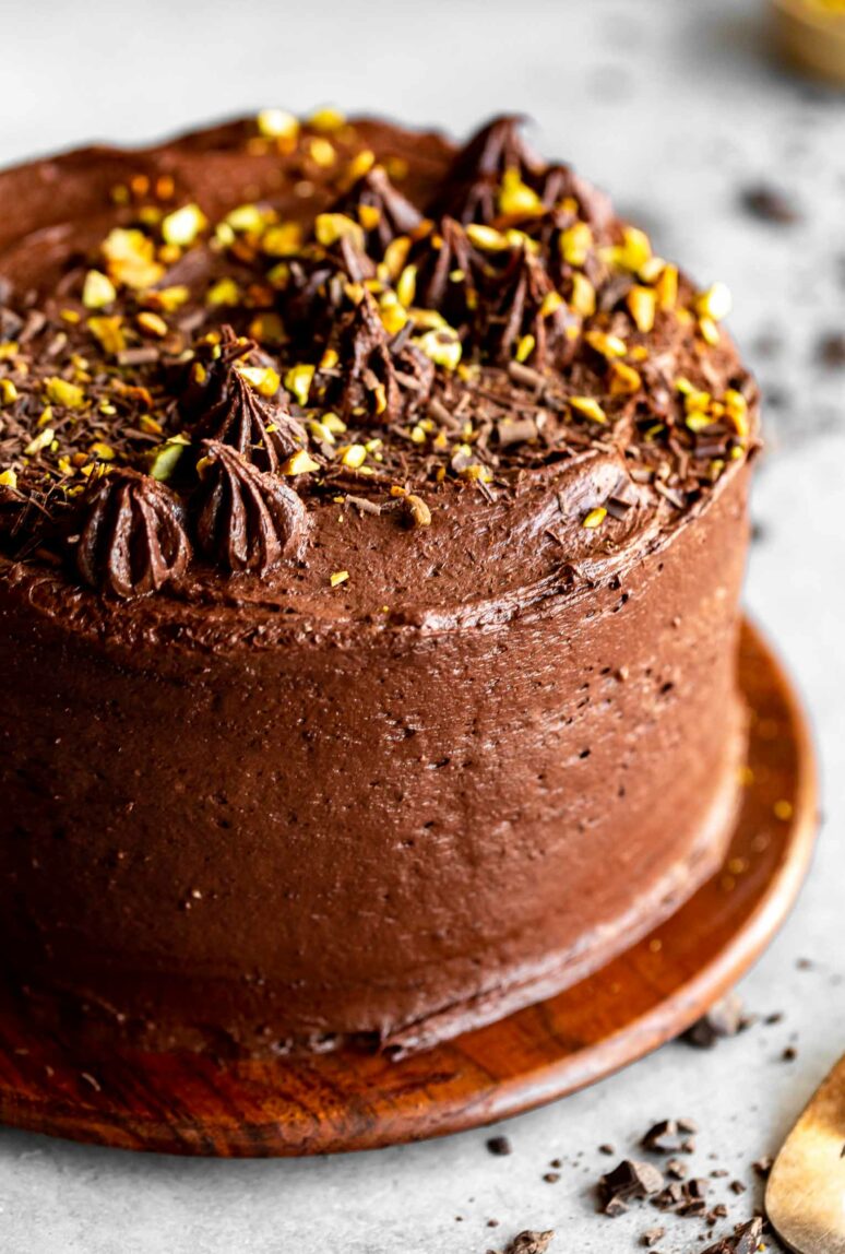 Beautiful healthy chocolate cake with tahini icing and pistachios.