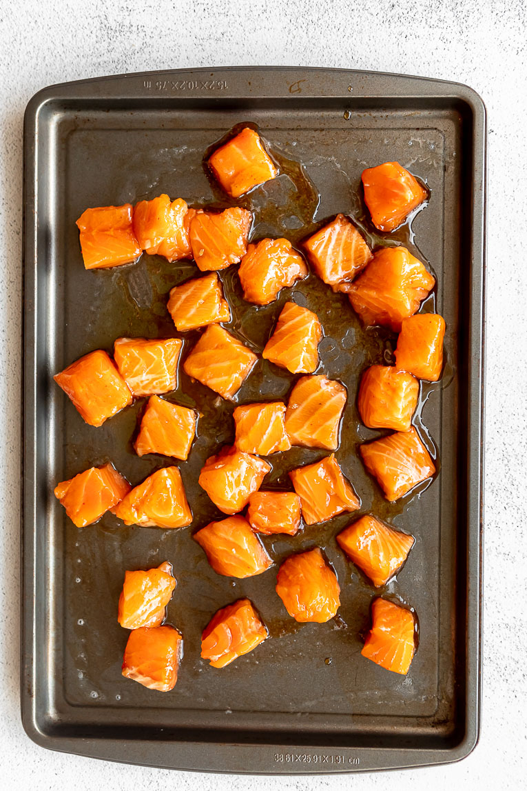 Honey glazed salmon on a baking sheet.